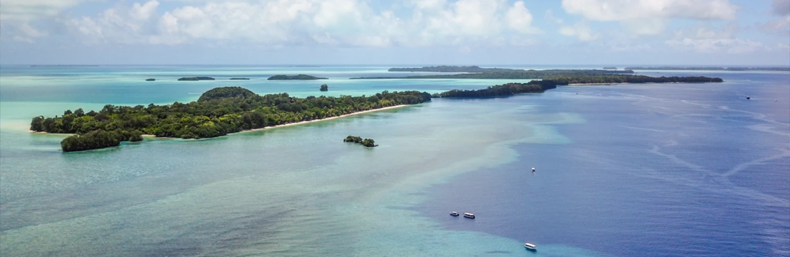 Aerial photo offering a look over Ngemelis Island in Palau, showing islands and dive boats